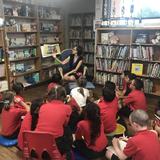 St. Jerome Elementary School Photo #7 - Students are engaged as they listen to a story being read to them in the school library.