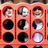 The Wesley School Photo #2 - Wesley Kindergarteners enjoy time outside playing a peek-a-boo version of Connect 4!