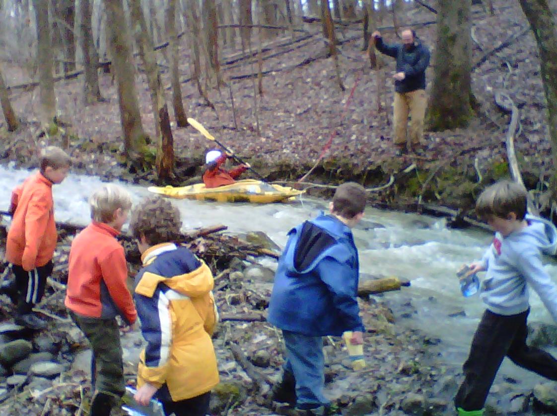Riley School Photo - Lower school children take turns trying kayaking in the stream on Riley Campus under the watchful eye of the Lower school teacher.