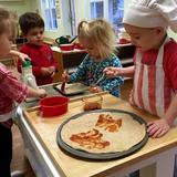 Montessori International Childrens House Photo #4 - The toddlers love making pizza for snack