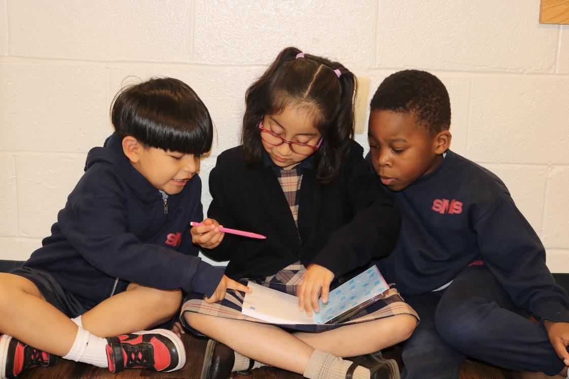 St. Martin of Tours School Photo #1 - Students from different grade levels learning and connecting together.