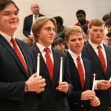 Catholic Memorial Photo #12 - Senior classmen hold candles during their commission Mass signifying that they have completed school and ready to leave to start another chapter of their lives.