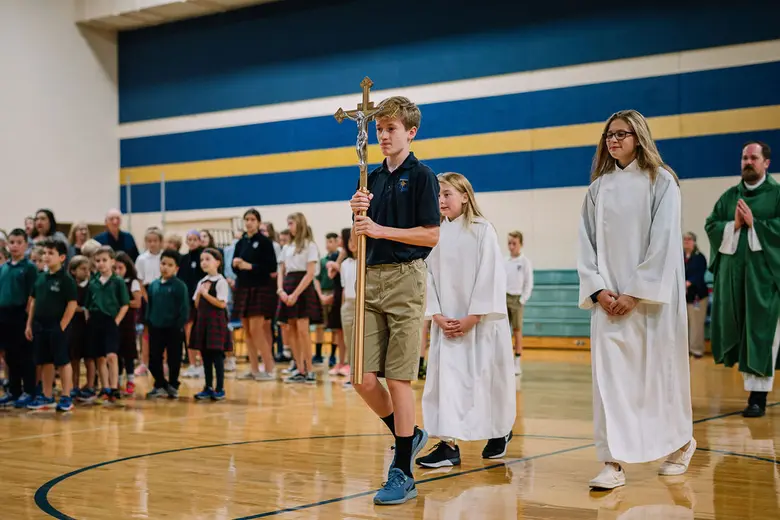 Faithful Shepherd Catholic School Photo - Every Wednesday our students celebrate mass together in our school gym. Students participate in the mass by leading the choir, reading, and carrying up the offertory gifts. Faith and service are closely linked. Students learn the importance of service to others through Advent and Lenten service projects, Monthly Faith in Action Fridays and Middle School service hours.