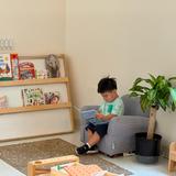 Chesterfield Montessori School Photo #8 - A Toddler student reading in their classroom.