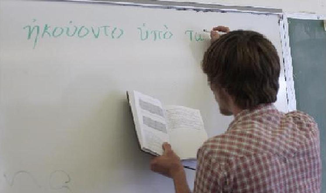 Mount Ellis Academy Photo - An MEA student transcribes a Greek sentence onto the whiteboard for translation.