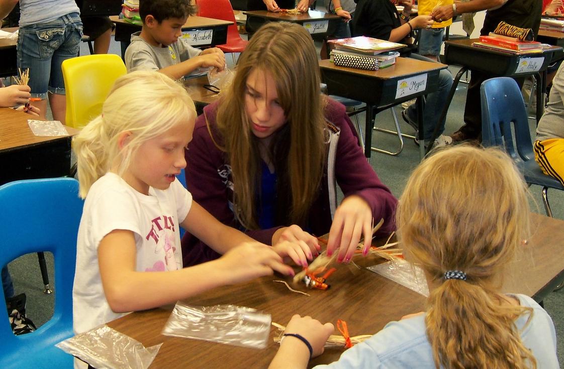Christ Lutheran School Photo - Upper and lower grade students work together on art project.