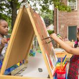 Montessori Parents Coop Photo - Two students enjoying painting outside in the sun!