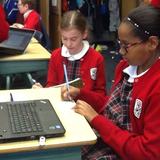 St. Cecilia Cathedral School Photo #10 - Researching on the laptops for 6th grade Invention Convention assessment project.