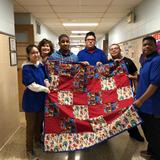 Bergen Center For Child Development Photo #2 - Bergen Center students displaying a beautiful hand made Quilt. The quilt was donated to a local children's hospital. The students and teacher were featured on Channel 7 News on the day they visited the hospital.