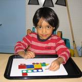 New World Montessori School Photo #7 - Puzzles and other lessons help develop spatial awareness skills.