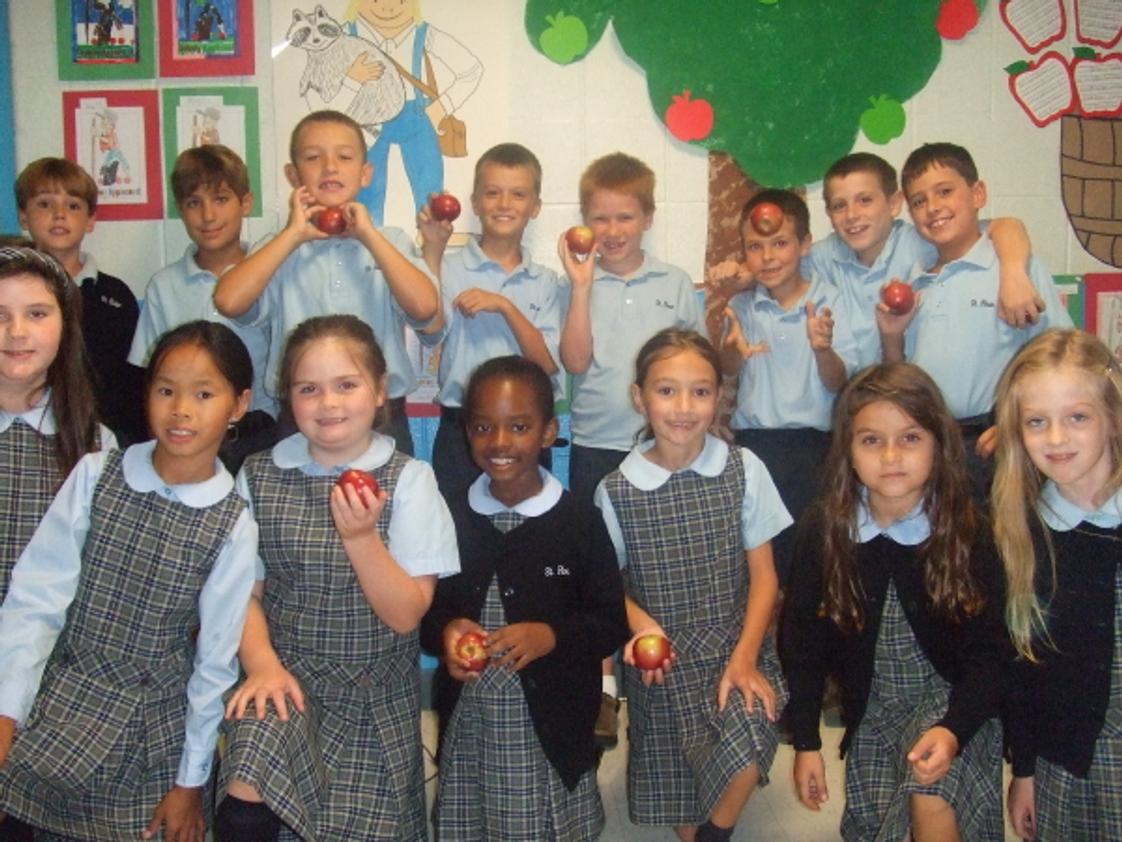 St. Rose Grammar School Photo #1 - St. Rose Grammar School third grade students from Ms. Mary Burns' class celebrated Johnny Appleseed's birthday by making homemade applesauce in their classroom.