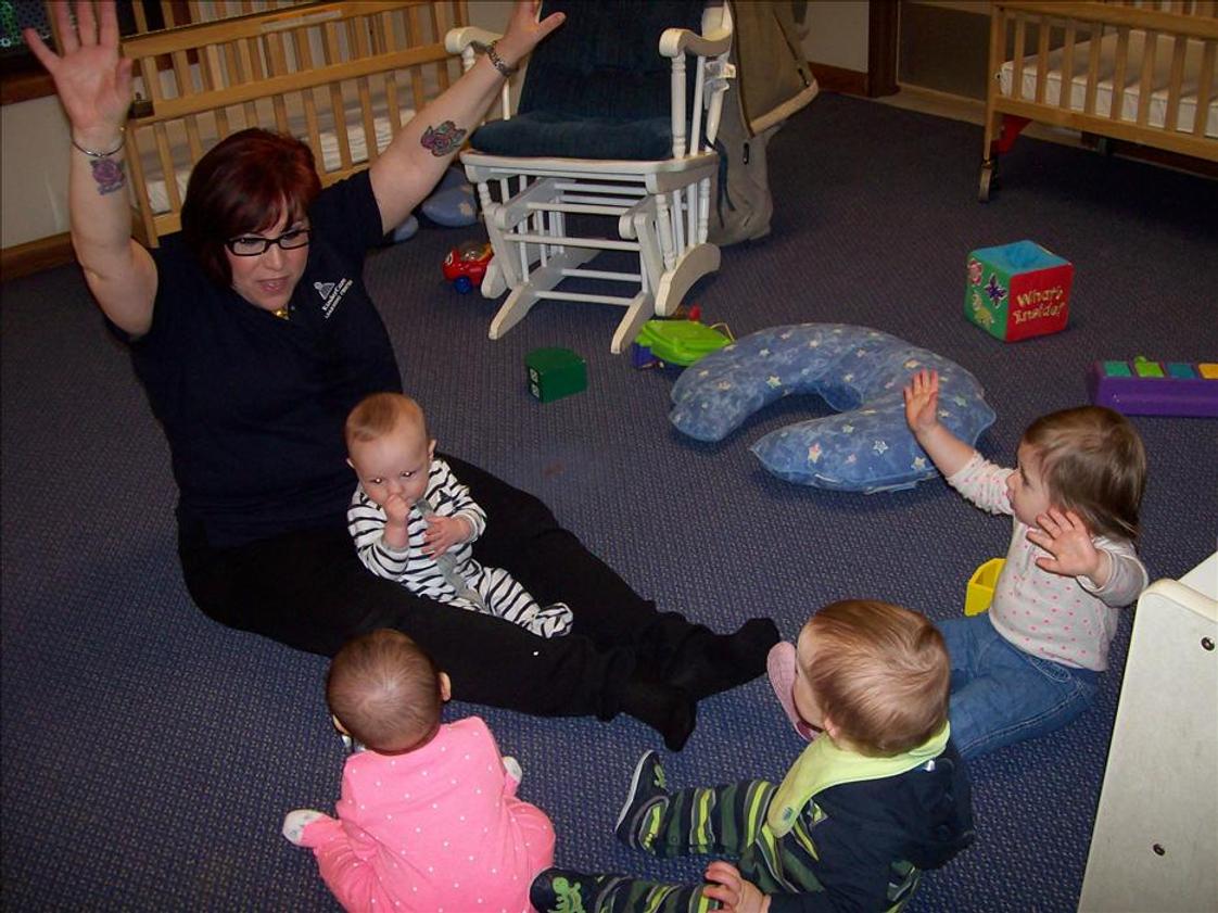 Springdale Road KinderCare Photo #1 - Ms. Lisa doing circle time with the infants.