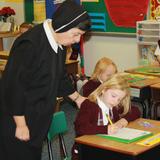 St. Thomas Aquinas School Photo #1 - Sister Anne Louise spends instructional time with STAS 1st grade class.