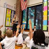 Buckley Country Day School Photo #2 - Kindergarten students eagerly raise their hands to share ideas and take part in a lively classroom discussion.