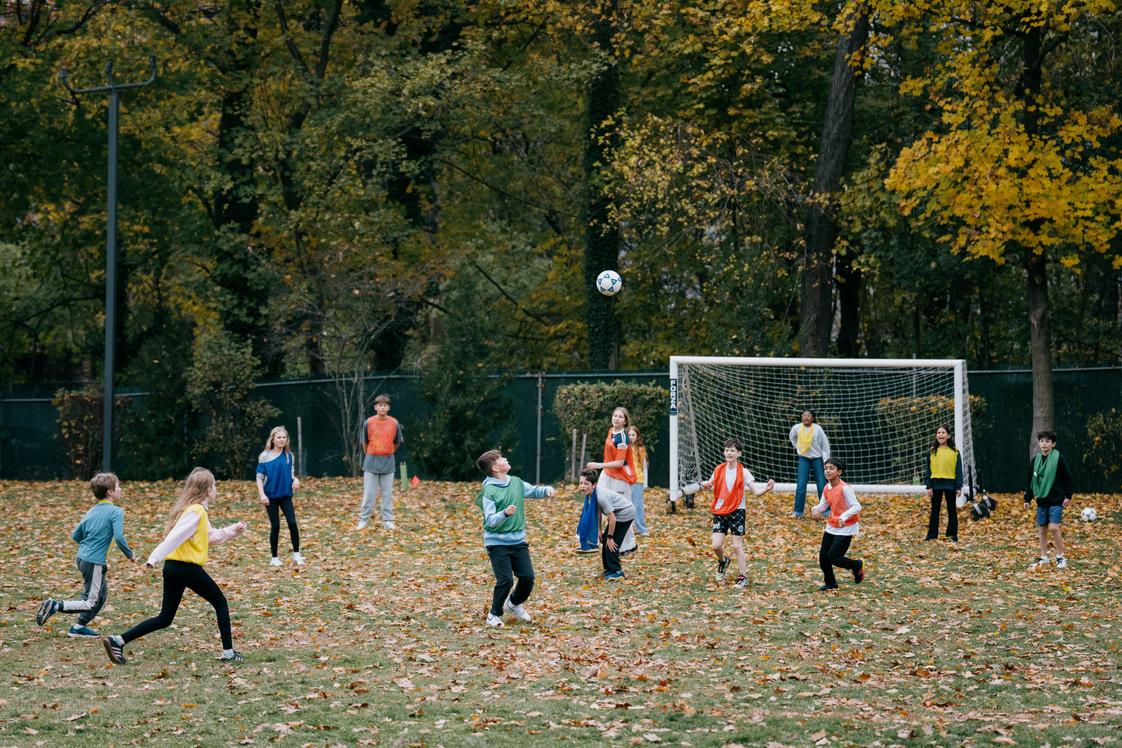 Riverdale Country School Photo #3 - Lower School students take PE outside, building teamwork, coordination, and confidence through sports and active play.