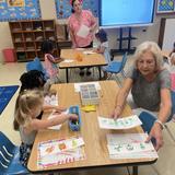 Sacred Heart School Photo #11 - Here Mrs. Reina, the assistant teacher in Pre-K 3, works with these two students on the sound of a letter.