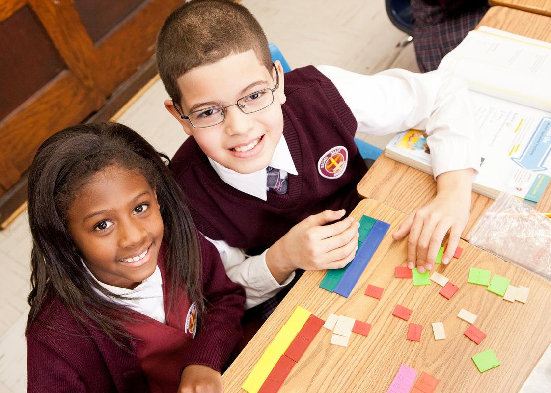 Sacred Heart School Photo - Third, fourth and fifth grade teachers ensure mastery of key math topics and, in ELA, students write longer, opinionated pieces so they can share their thoughts with others. As it is with all students in Sacred Heart, character and spiritual education unify all aspects of the curriculum.