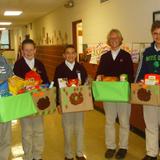 St. John School Photo #1 - Grade 8 boys help with some of the Thanksgiving baskets that were collected for needy families for House on the Hill in Goshen.