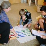 Greensboro Montessori School Photo #6 - Second the third graders in our Lower Elementary program receive a math lesson using hand-on materials which help students understand exchanges in mathematical operations.