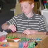 Alexandria Montessori School Photo - Students learn long division using the Montessori material "Test Tube"