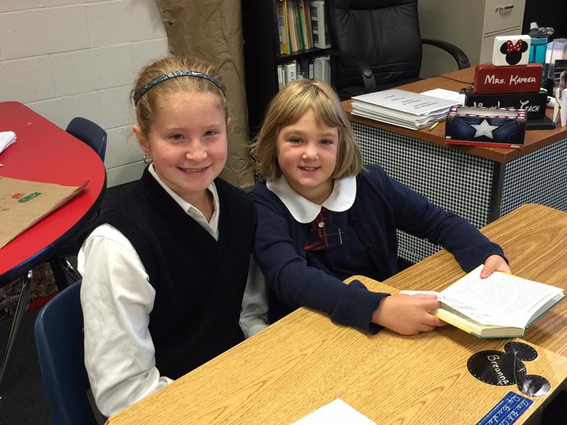New Hope Christian Academy Photo #1 - 6th Grade collaborative reading with 3rd Grade.