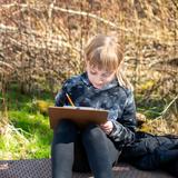 French International School of Oregon Photo #5 - Third grade working on creative writing while enjoying the sunshine in the French International forest.