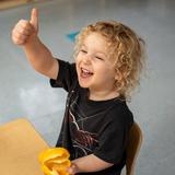 French International School of Oregon Photo #6 - Preschool students learning about their senses by smelling and tasting yellow foods.