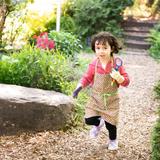 Whole Child Montessori Center Photo #1 - Child running through the Children's Garden at Whole Child Montessori Center in SE Portland