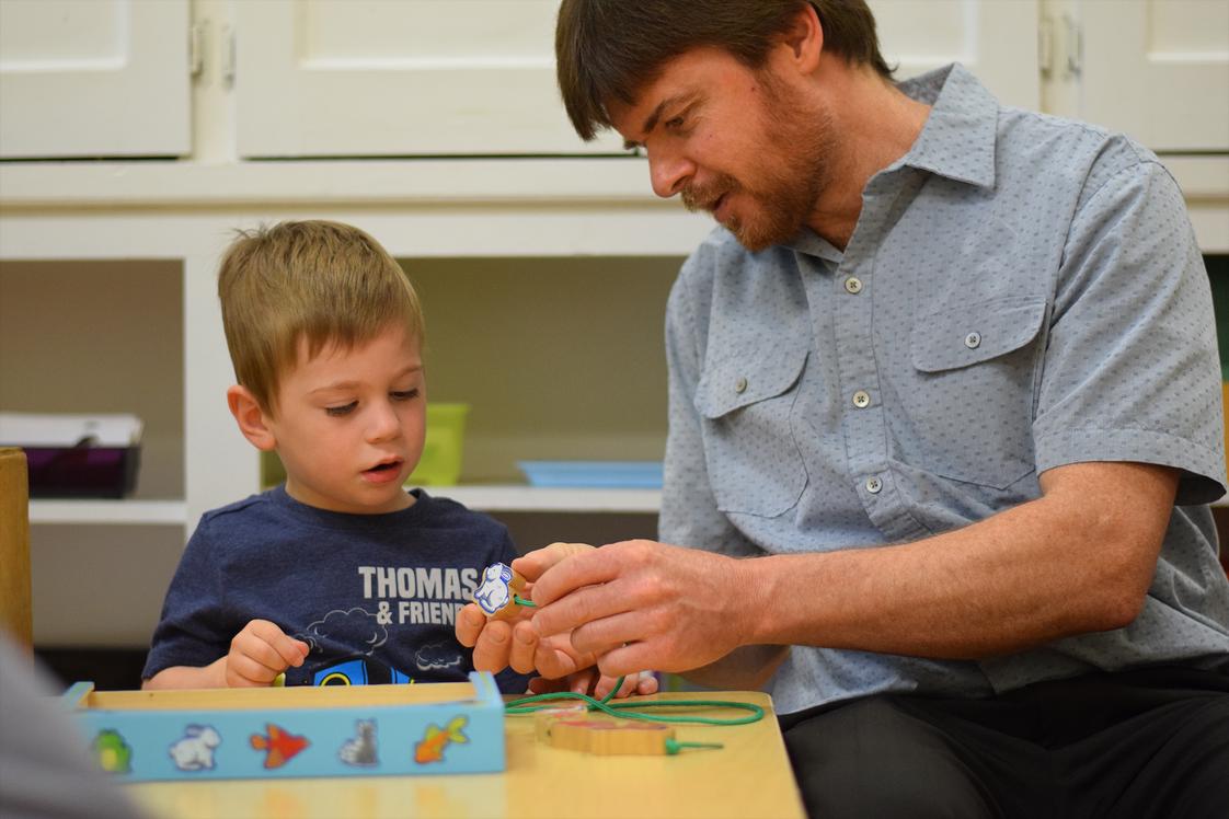 Gladwyne Montessori Photo - Primary teacher giving a lesson to 2 year old student in preparation for his transition into a 3-6 year old classroom.
