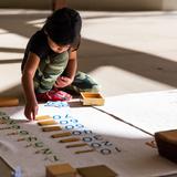 Abintra Montessori School Photo #3 - Lower School student working on The Big Display (a Math lesson)