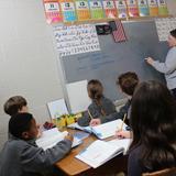 St. Joseph School Photo #4 - Our Learning Specialist, Mrs. Steigerwald, helps 5th grade students through a Math equation.