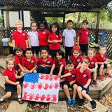 Epiphany Montessori School Photo - Epiphany students showing off their hand-made U.S. Flag in observance of Veteran's Day.