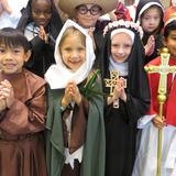 All Saints Catholic School Photo #3 - Our feast day celebration includes many traditions, including our 3rd Grade Saints Procession at Mass, the raising of the Saints banners, Saint Puppet presentations by our second graders, and the Saints Cafe which features our middle school students sharing the lives of the saints in a large assembly and from classroom to classroom.