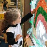 French Immersion School Of Washington Photo #5 - A Pre-School student is decorating the window with colored papers.