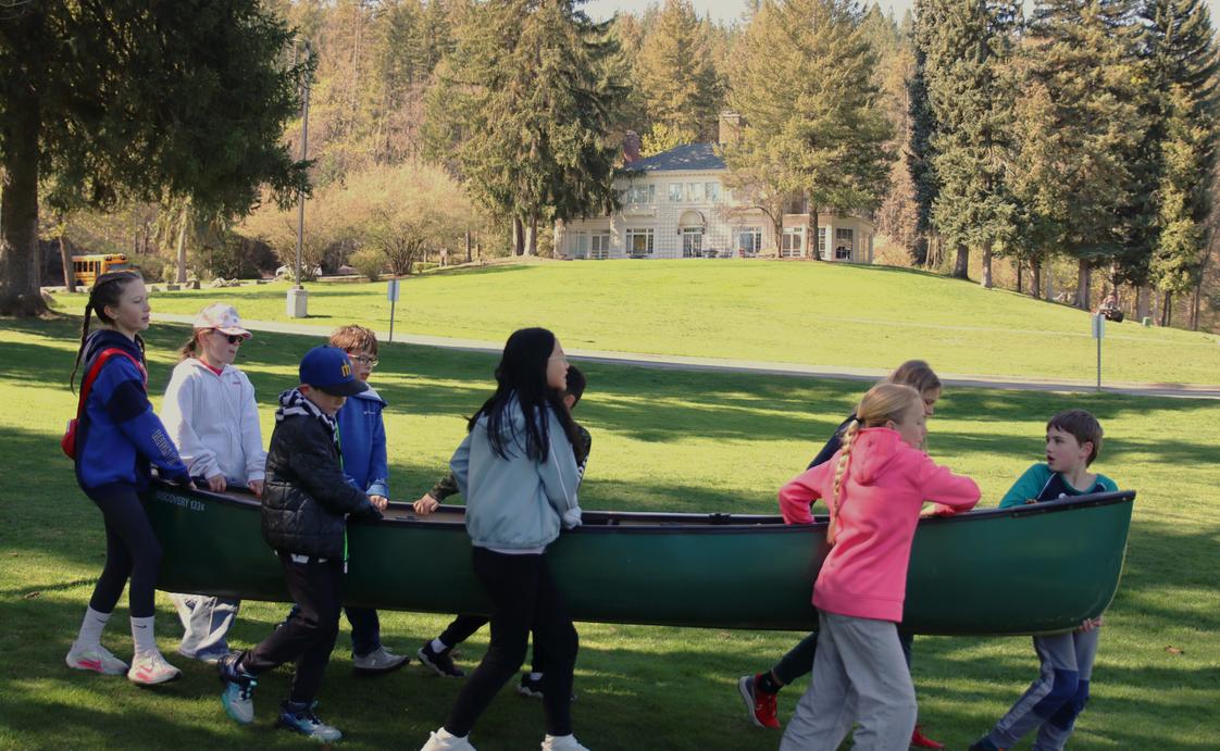 Saint George's School Photo #8 - Lower School students practice portaging a canoe around campus trees and down to the Little Spokane River, that flows right past Saint George's campus.