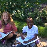 The Phoenix School Photo - Getting outdoors is important part of a Phoenix education. Here, we're using one of the Peabody Essex Museum's historic houses with a beautiful garden to be bontanists, taking notes and drawing the flowers we see. Later we will add notes about the parts and their functions of each flower/plant we draw.