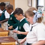 The Oaks Academy Photo #18 - 3rd grade student practice their notes on the xylophone in music class.