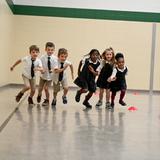 The Oaks Academy Photo #20 - Students race in the gym during PE, a weekly special.