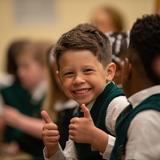 The Oaks Academy Photo #5 - A student smiles and gives a thumbs up as they wait for the rest of the school to arrive for chapel.