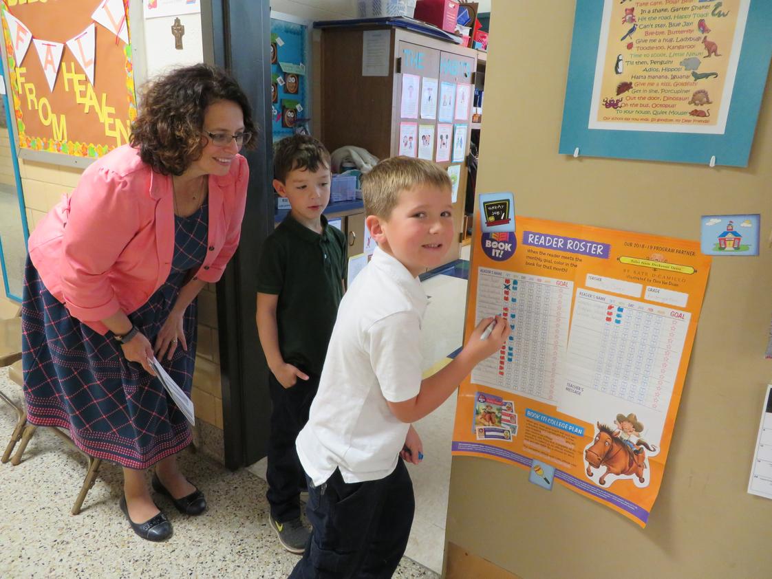 Holy Cross Catholic School Photo #1 - Principal Reinhart helping a kindergarten student chart his goals. Holy Cross Catholic School, Defiance Ohio. #Greathappenshere!