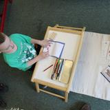 The Happy Childrens Montessori Photo #4 - Children love learning about animals. This boy is making a "parts of the otter" booklet.