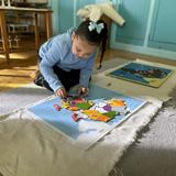Racine Montessori School Photo - Children piece together continents and countries, learning geography through touch and exploration.This work builds spatial awareness, cultural curiosity, and respect for our planet - one map at a time.