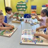 Kids Adventure Learning Center Photo #12 - Toddler Class hard at work. Making sure to assist, guide, and foster the most formative skills with great hand eye coordination, fine motor skills, and so much more! Our 18-36 month classroom is a great place to start your Preschool Adventure!