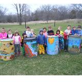 Natures Classroom Institute & Montessori School Photo #2 - Students proudly showing their colorfully painted rain barrels.