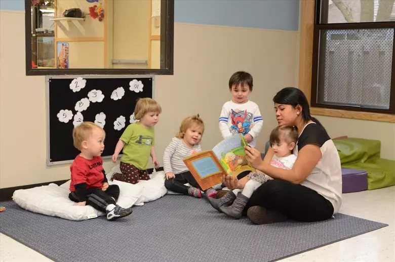 Lisle College Road KinderCare Photo #2 - Miss Sarom keeps the toddlers engaged with an interactive story.