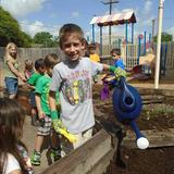 Clear Lake KinderCare Photo #5 - Watering the garden to help it grow