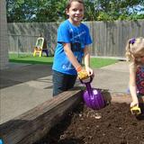 Clear Lake KinderCare Photo - Getting the soil ready for planting our seeds