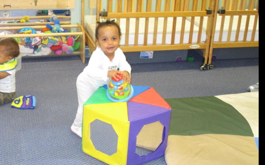 St. Charles KinderCare Photo #1 - Learning to stand and balance in the infant classroom.