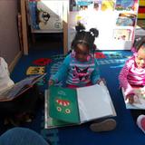 Woodridge South KinderCare Photo #10 - Jamyah, Eric, and Kiley love looking at books and working on literacy.