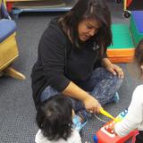 Round Lake Heights KinderCare Photo #4 - Ms Jessica playing music with the students in the Infant class